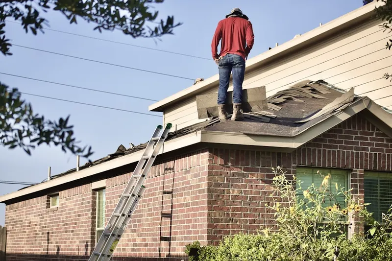 Professional roofer working on a residential roof in Chestnut Point Estates
